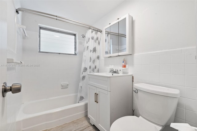 2946 SW 26th St, Miami, FL 33133 - bathroom with shower / tub combo with curtain, vanity, wood finished floors, tile walls, and wainscoting