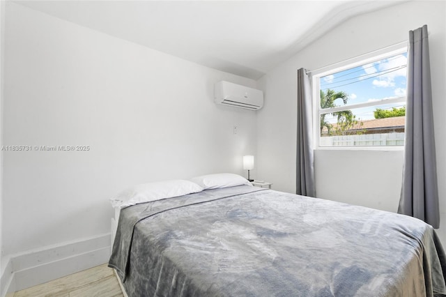 2946 SW 26th St, Miami, FL 33133 - bedroom with an AC wall unit, lofted ceiling, and wood finished floors