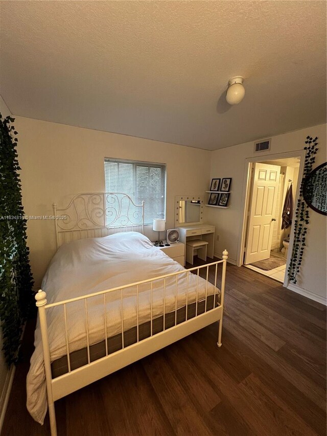 2548 Centergate Dr Unit 301, Miramar, FL 33025 - bedroom featuring wood finished floors and a textured ceiling