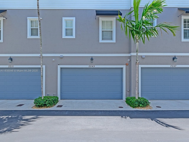 2249 NE 9th Ave, Wilton Manors, FL 33305 - view of front of property with stucco siding and an attached garage