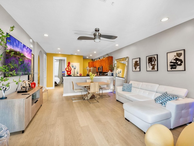 2249 NE 9th Ave, Wilton Manors, FL 33305 - living room featuring ceiling fan, light wood-style flooring, recessed lighting, and arched walkways