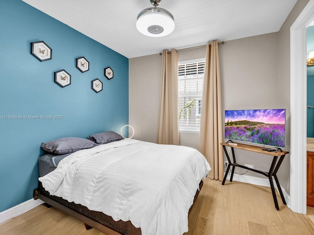2249 NE 9th Ave, Wilton Manors, FL 33305 - bedroom with light wood-type flooring and baseboards