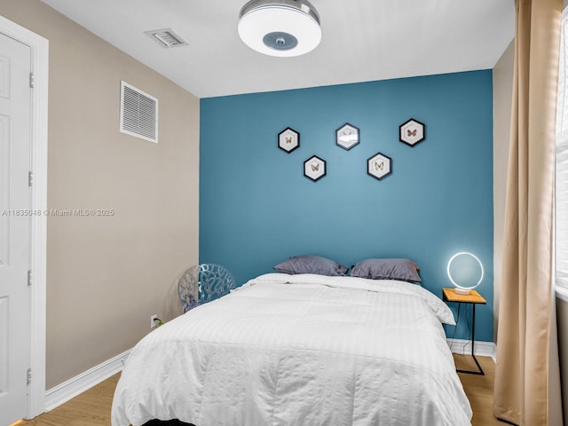 2249 NE 9th Ave, Wilton Manors, FL 33305 - bedroom with wood finished floors and an accent wall