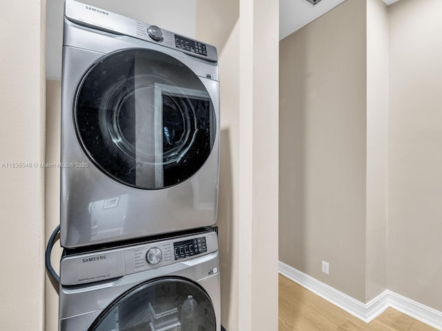 2249 NE 9th Ave, Wilton Manors, FL 33305 - washroom with estacked washer and dryer and wood finished floors
