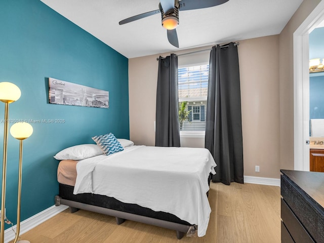 2249 NE 9th Ave, Wilton Manors, FL 33305 - bedroom with light wood-style flooring and a ceiling fan