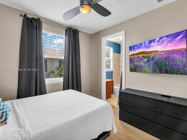 2249 NE 9th Ave, Wilton Manors, FL 33305 - bedroom featuring multiple windows, connected bathroom, and a ceiling fan