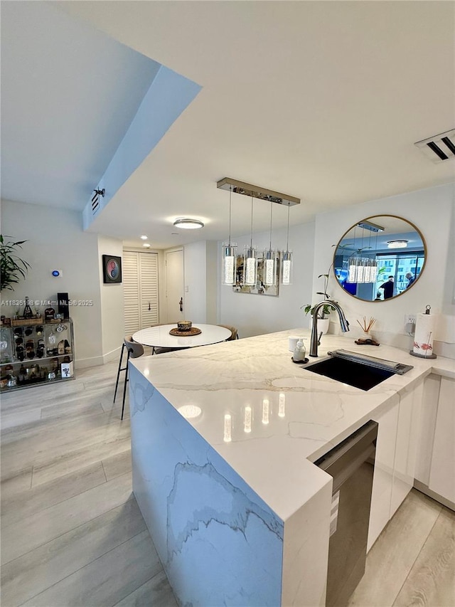 770 Claughton Island Dr Unit 1503, Miami, FL 33131 - kitchen featuring modern cabinets, stainless steel dishwasher, light stone countertops, and light wood-type flooring