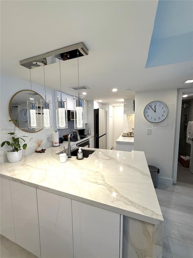 770 Claughton Island Dr Unit 1503, Miami, FL 33131 - kitchen featuring freestanding refrigerator, white cabinetry, a peninsula, light stone countertops, and recessed lighting