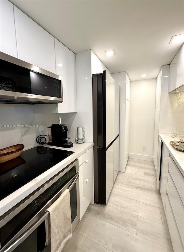 770 Claughton Island Dr Unit 1503, Miami, FL 33131 - kitchen featuring appliances with stainless steel finishes, modern cabinets, white cabinetry, and light countertops
