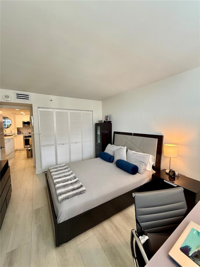 770 Claughton Island Dr Unit 1503, Miami, FL 33131 - bedroom with light wood-style floors, a desk, and a closet