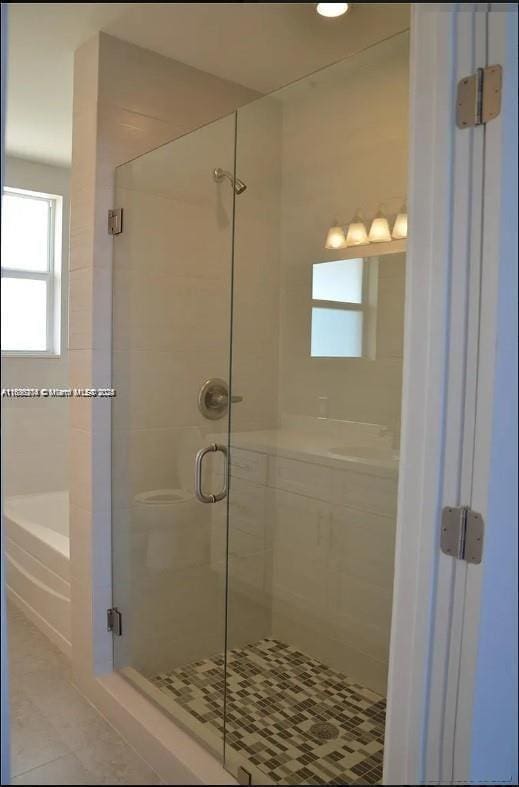 555 E Dania Beach Blvd Unit 5, Dania Beach, FL 33004 - bathroom with a stall shower, a garden tub, and tile patterned floors