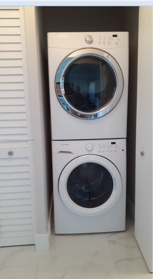 555 E Dania Beach Blvd Unit 5, Dania Beach, FL 33004 - washroom with estacked washer and dryer and light marble finish flooring