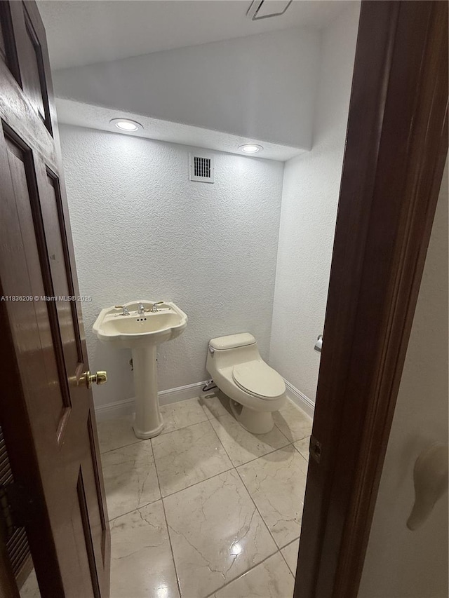 15051 SW 149th St, Miami, FL 33196 - half bath featuring marble look tiles, vaulted ceiling, and a textured wall