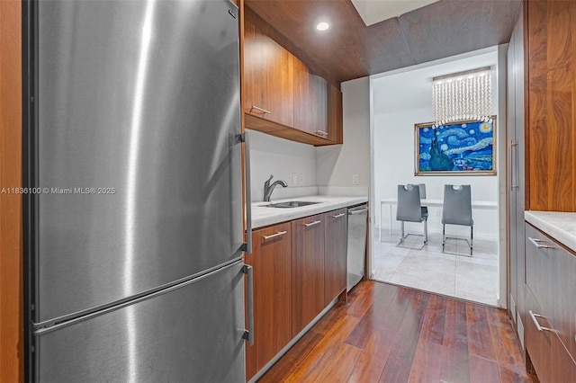 50 Biscayne Blvd Unit 601, Miami, FL 33132 - kitchen with stainless steel appliances, light countertops, dark wood-type flooring, recessed lighting, and brown cabinets