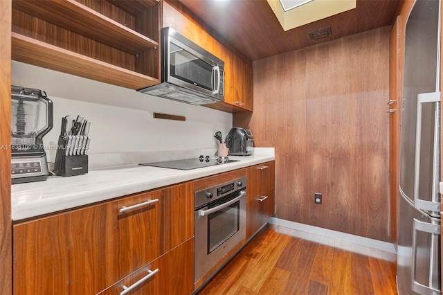 50 Biscayne Blvd Unit 601, Miami, FL 33132 - kitchen with appliances with stainless steel finishes, brown cabinetry, modern cabinets, and light countertops