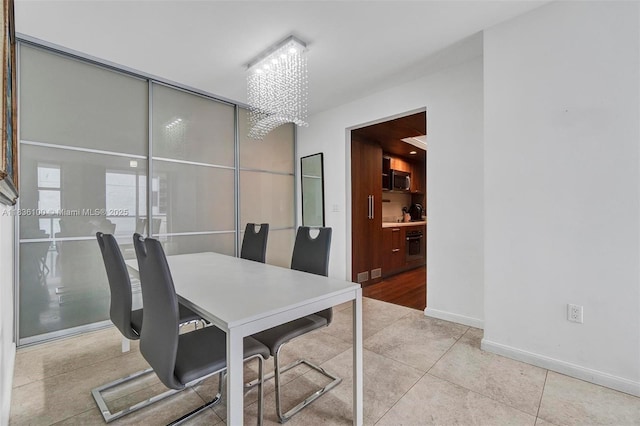 50 Biscayne Blvd Unit 601, Miami, FL 33132 - tiled dining area with a chandelier and baseboards