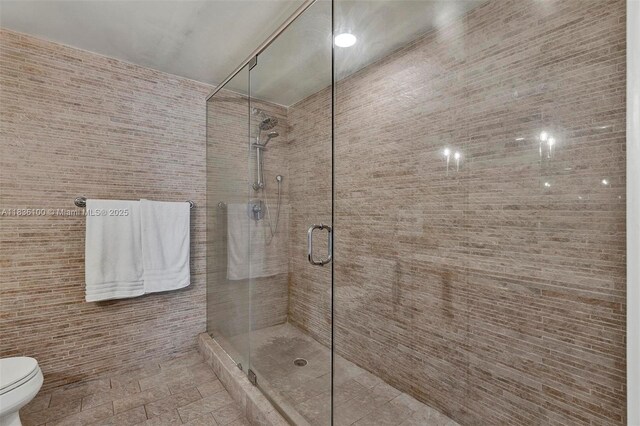 50 Biscayne Blvd Unit 601, Miami, FL 33132 - full bathroom featuring a stall shower and tile walls