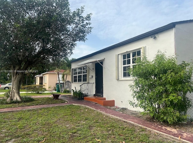8921 NW 17th Ave, Miami, FL 33147 - view of front of house with stucco siding and a front yard