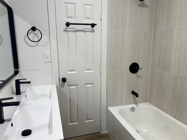 8921 NW 17th Ave, Miami, FL 33147 - bathroom featuring a textured wall, shower / bathtub combination, and double vanity