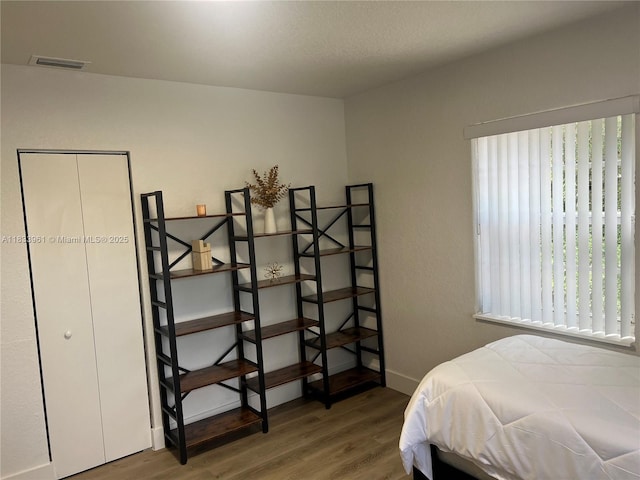 8921 NW 17th Ave, Miami, FL 33147 - bedroom featuring wood finished floors and baseboards