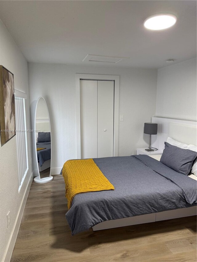 8921 NW 17th Ave, Miami, FL 33147 - bedroom featuring wood finished floors, a closet, and attic access