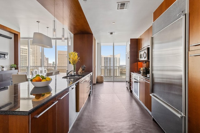901 Brickell Key Blvd Unit 3607, Miami, FL 33131 - kitchen with stainless steel appliances, expansive windows, modern cabinets, a city view, and dark stone counters