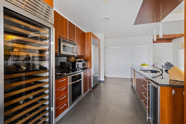 901 Brickell Key Blvd Unit 3607, Miami, FL 33131 - kitchen featuring beverage cooler, appliances with stainless steel finishes, brown cabinets, and modern cabinets