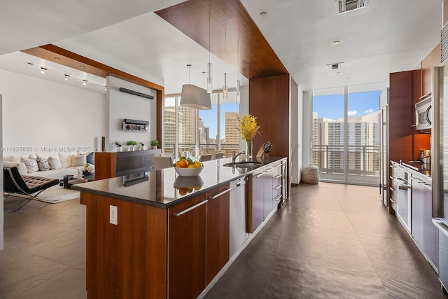 901 Brickell Key Blvd Unit 3607, Miami, FL 33131 - kitchen featuring modern cabinets, a wall of windows, appliances with stainless steel finishes, plenty of natural light, and decorative light fixtures