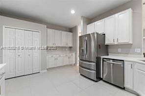 1851 Soaring Hights Cir, Orlando, FL 32837 - kitchen with appliances with stainless steel finishes, white cabinets, light countertops, and recessed lighting