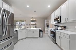 1851 Soaring Hights Cir, Orlando, FL 32837 - kitchen featuring appliances with stainless steel finishes, white cabinetry, light countertops, recessed lighting, and a peninsula