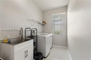 1851 Soaring Hights Cir, Orlando, FL 32837 - laundry room with separate washer and dryer and baseboards