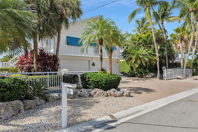 126 Villa Bella Dr, Islamorada, FL 33036 - view of front of home featuring a garage, a balcony, and driveway