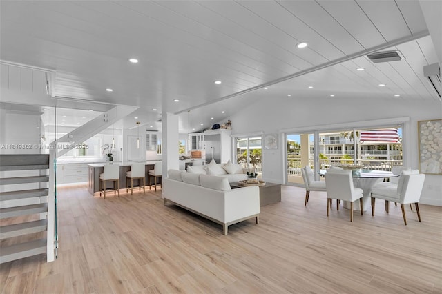 126 Villa Bella Dr, Islamorada, FL 33036 - living room with lofted ceiling, light wood finished floors, recessed lighting, and stairway