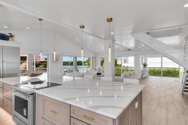 126 Villa Bella Dr, Islamorada, FL 33036 - kitchen with stainless steel range with electric cooktop, open floor plan, healthy amount of natural light, light wood finished floors, and recessed lighting