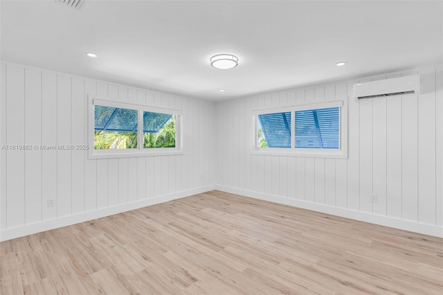 126 Villa Bella Dr, Islamorada, FL 33036 - empty room featuring a wall unit AC, light wood finished floors, and recessed lighting