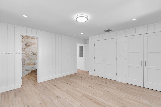 126 Villa Bella Dr, Islamorada, FL 33036 - unfurnished bedroom with light wood-type flooring, multiple closets, electric panel, and recessed lighting