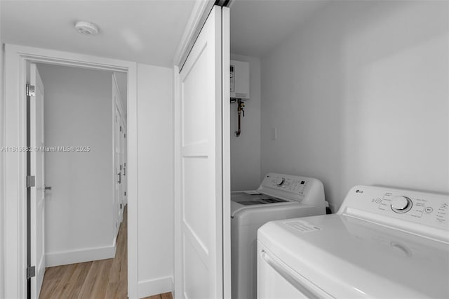 126 Villa Bella Dr, Islamorada, FL 33036 - washroom featuring light wood finished floors, separate washer and dryer, and water heater