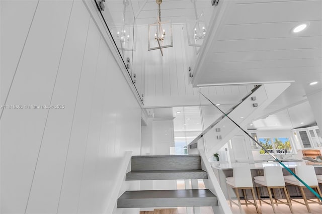 126 Villa Bella Dr, Islamorada, FL 33036 - stairway featuring a chandelier and recessed lighting