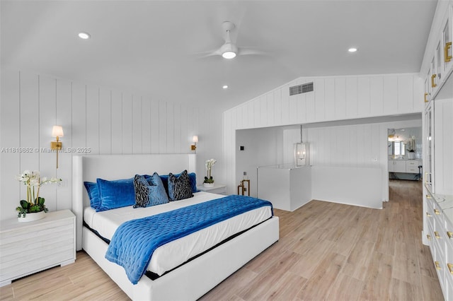 126 Villa Bella Dr, Islamorada, FL 33036 - bedroom with light wood-style flooring, lofted ceiling, ceiling fan, and wood walls