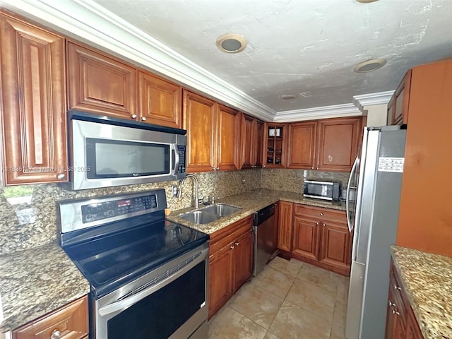 6707 Brookline Dr Unit 6707, Hialeah, FL 33015 - kitchen featuring stainless steel appliances, brown cabinetry, tasteful backsplash, light stone counters, and crown molding