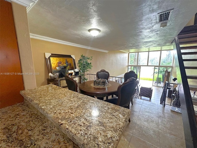 6707 Brookline Dr Unit 6707, Hialeah, FL 33015 - dining area featuring a textured ceiling, tile patterned flooring, and ornamental molding
