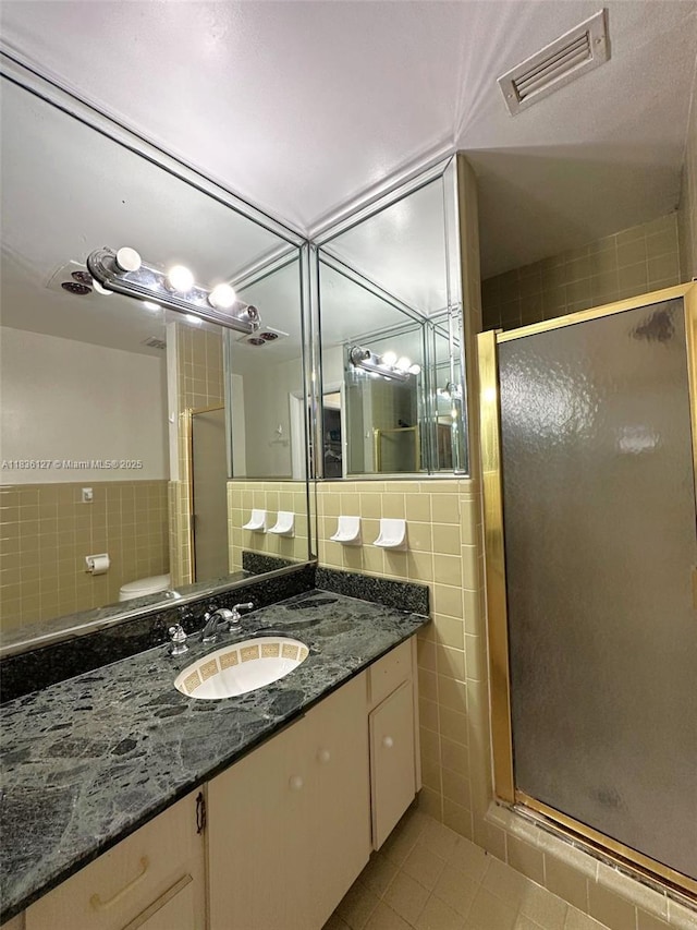 6707 Brookline Dr Unit 6707, Hialeah, FL 33015 - bathroom with tile walls, tile patterned flooring, a stall shower, and vanity