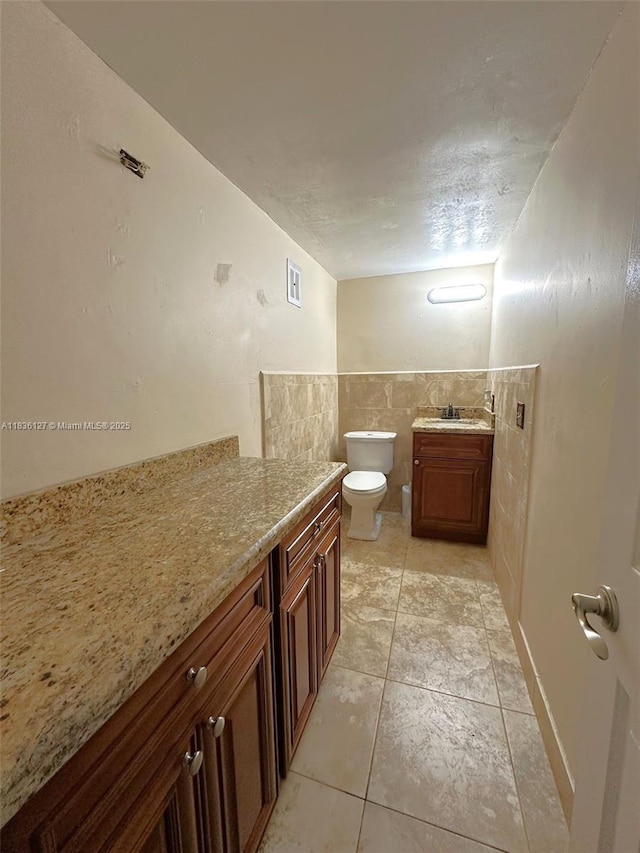 6707 Brookline Dr Unit 6707, Hialeah, FL 33015 - bathroom with vanity, tile walls, tile patterned flooring, and a wainscoted wall