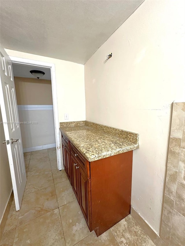 6707 Brookline Dr Unit 6707, Hialeah, FL 33015 - kitchen with light stone counters, brown cabinets, and light tile patterned flooring