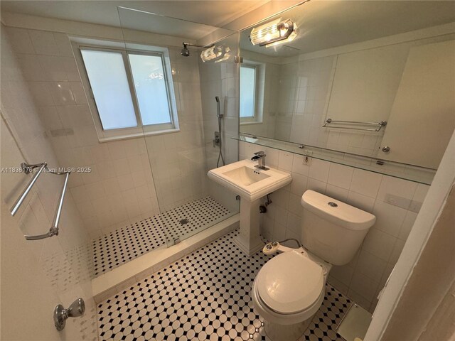 4780 Pine Tree Dr Unit U-2, Miami Beach, FL 33140 - bathroom featuring a walk in shower and tile walls