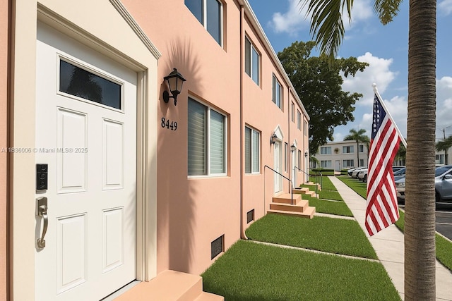 8449 NW 4th Ave Unit 8449, Miami, FL 33150 - view of exterior entry featuring stucco siding and a lawn