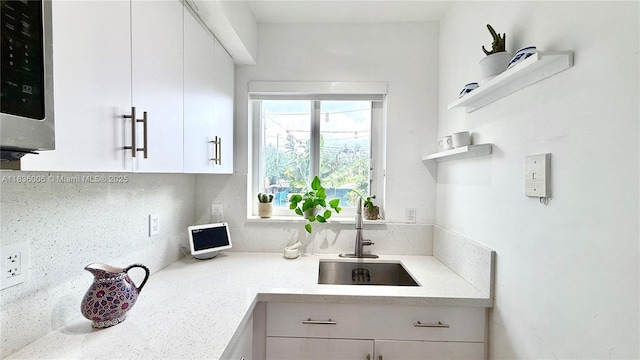 8449 NW 4th Ave Unit 8449, Miami, FL 33150 - kitchen featuring stainless steel microwave, white cabinets, and open shelves