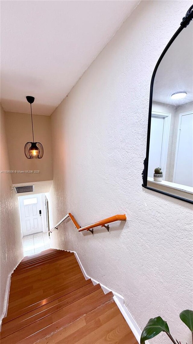 8449 NW 4th Ave Unit 8449, Miami, FL 33150 - staircase featuring a textured wall and wood finished floors