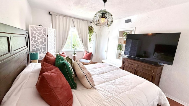 8449 NW 4th Ave Unit 8449, Miami, FL 33150 - bedroom featuring a chandelier, a textured wall, and a textured ceiling