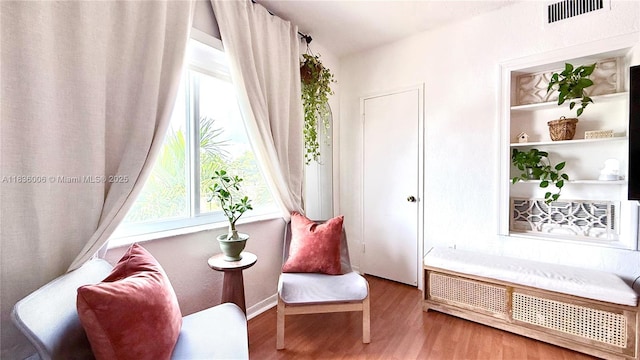 8449 NW 4th Ave Unit 8449, Miami, FL 33150 - living area featuring wood finished floors, healthy amount of natural light, and radiator heating unit